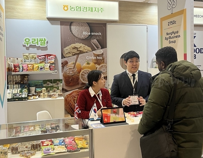 농협경제지주는 지난 17일부터 3일간「 영국 국제식품박람회(IFE 2025)」에 참가해 농협의 농식품을 홍보한다. 농협경제지주 직원이 한국관 홍보 부스에서 외국인에게 쌀 가공식품에 대해 설명하고 있다.